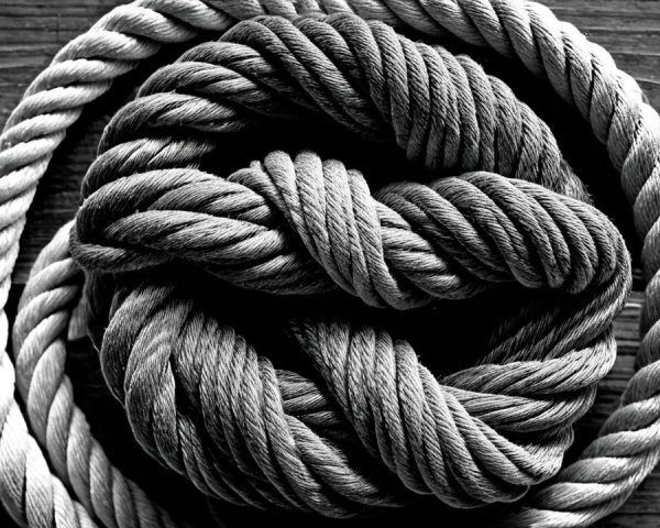 Coiled Rope Knot on Rustic Wooden Surface
