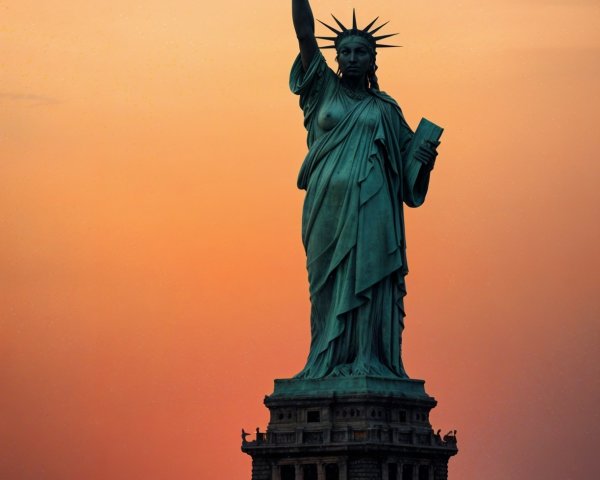 Statue of Liberty at Sunset with Flying Saucers