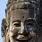 Stone Face of Smiling Deity at Bayon Temple, Cambodia