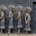 Five Identical Girls in Elegant Gray Dresses Against Wall