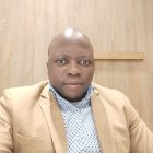 Life-like figure in beige blazer with stern expression
