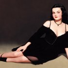 Young woman in black dress with purple heart nearby