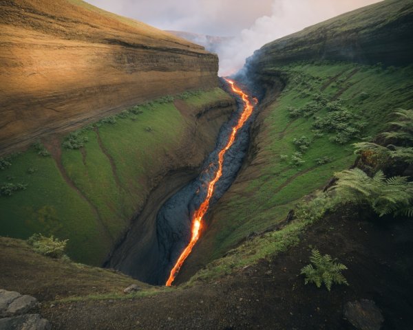 Narrow Canyon with Flowing Lava and Green Cliffs