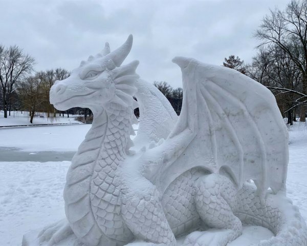 Detailed Snow Sculpture of a Dragon in Winter Scene