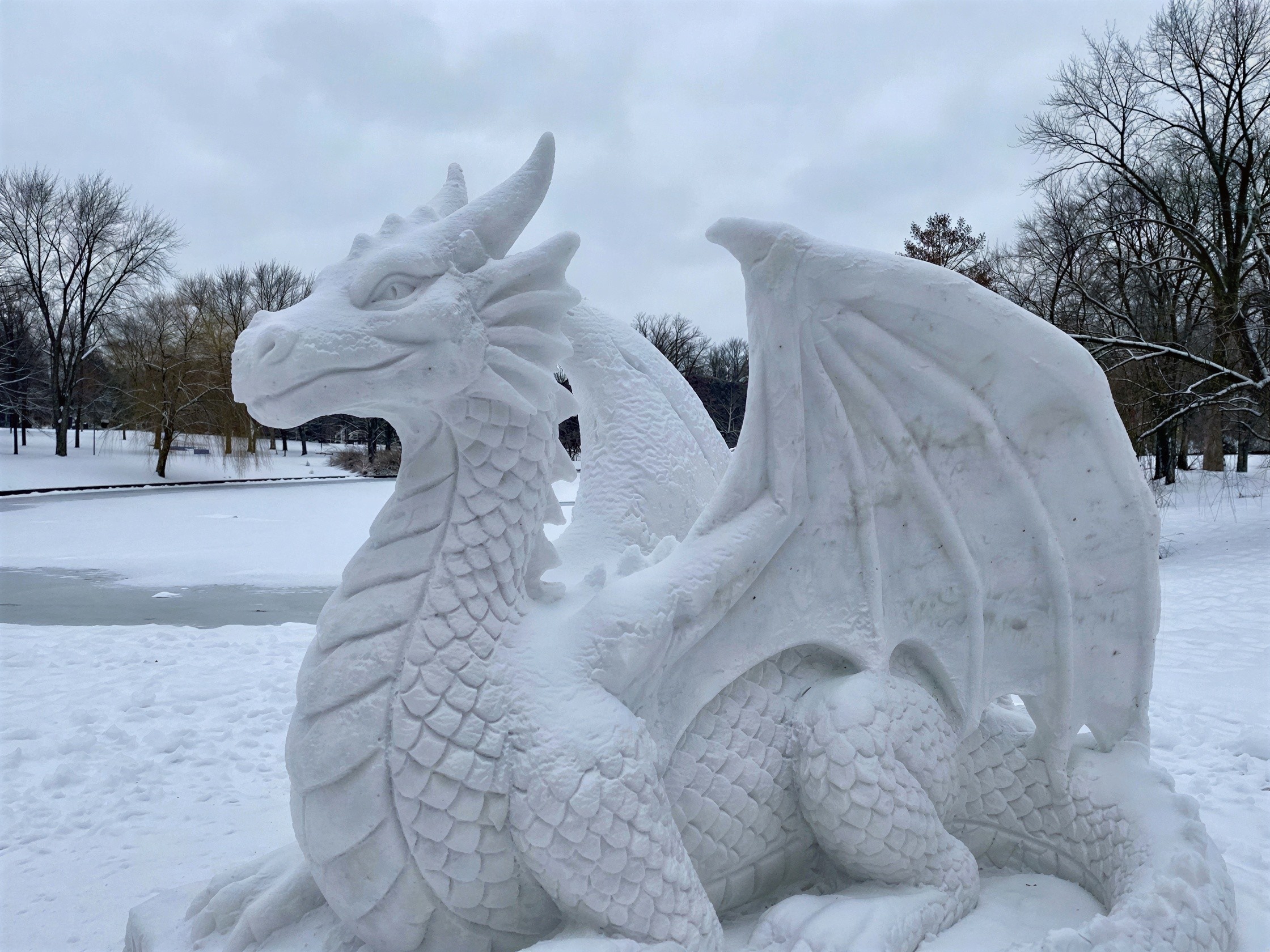 Detailed Snow Sculpture of a Dragon in Winter Scene