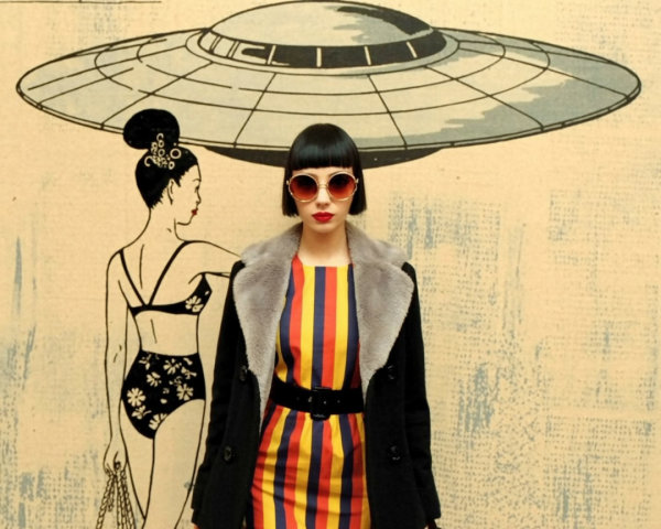Stylish Woman in Vintage Setting with Retro UFO