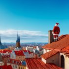 Rooftop Scene with Woman, Cat, and Hot Air Balloons