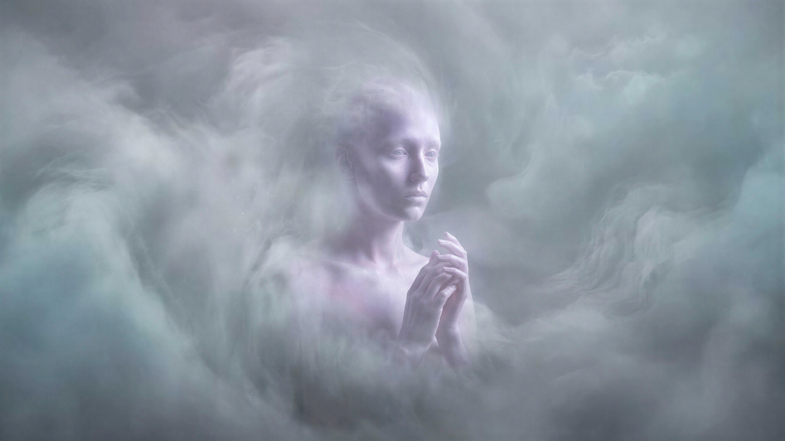 Woman with pale skin in light blue fog and halo