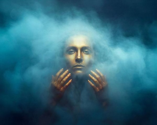 Dramatic Portrait of Golden-Skinned Figure in Smoke