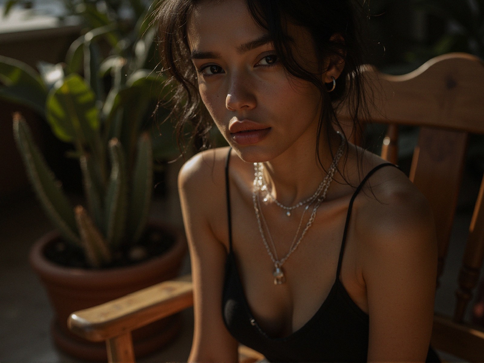 Young woman in sunlight with layered pearl necklaces