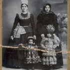 Vintage Attire of Four Women in Somber Landscape