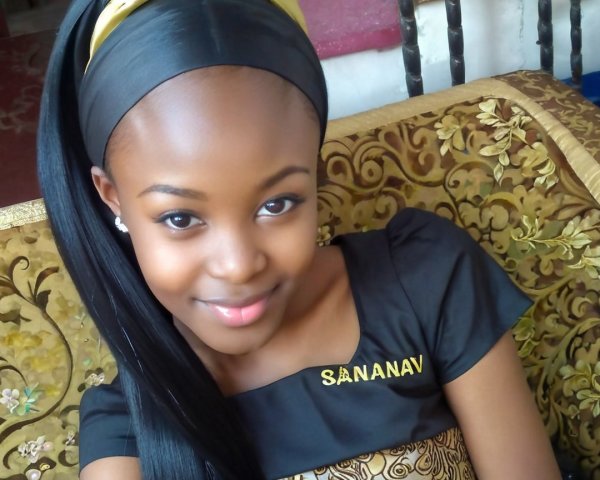 Young girl in stylish black outfit with golden accents