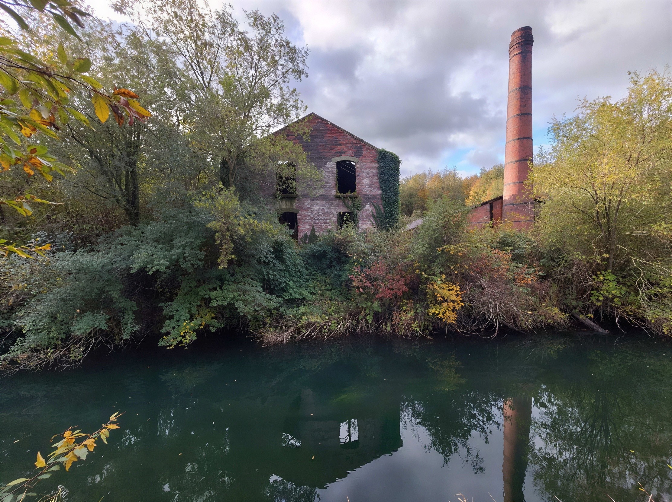 Old Brick Factory with Chimney by Blue-Green Water