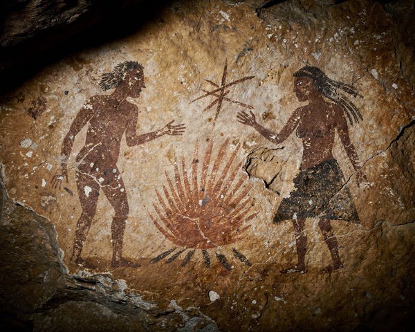 Cave Painting of Male and Female Figures on Rock Wall