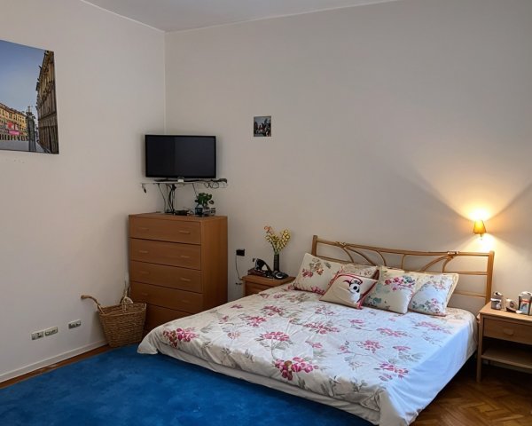 Cozy Bedroom with Floral Bedding and Warm Lighting