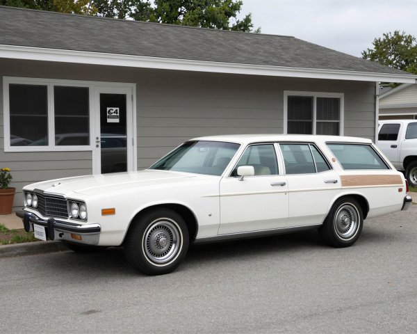 Vintage white station wagon with wood paneling parked