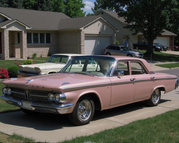 Classic Pink 1960s Sedan in Suburban Driveway Setting