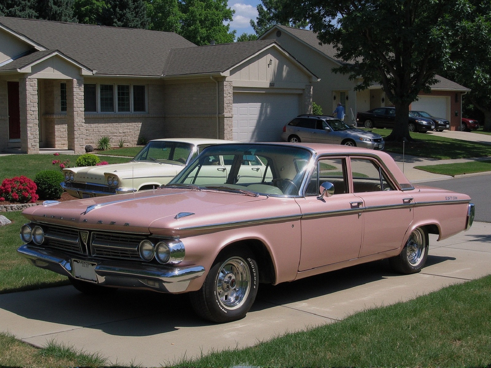 Classic Pink 1960s Sedan in Suburban Driveway Setting