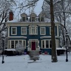 Two-Story Blue House in Winter Landscape