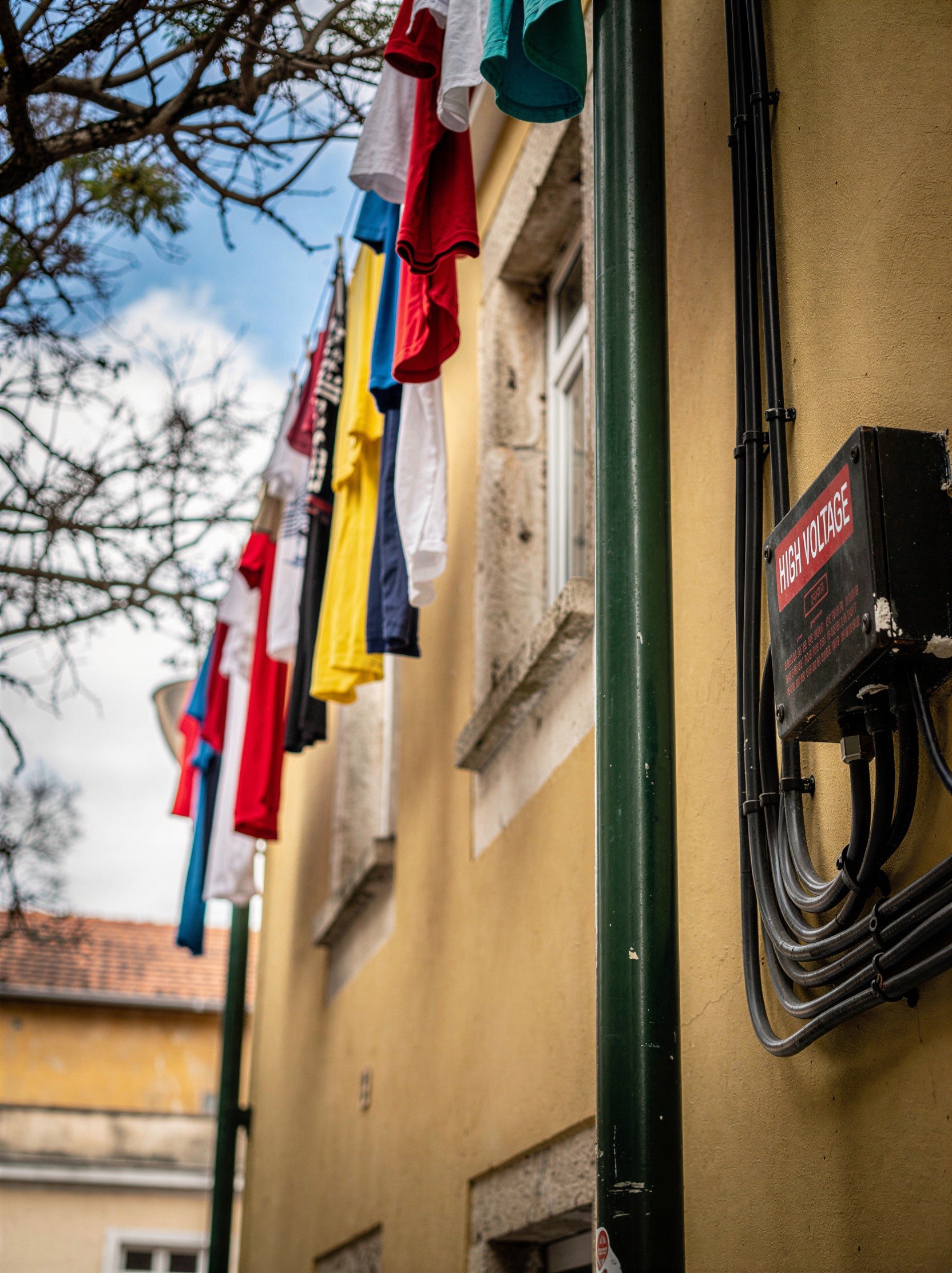 Close-up of Yellow Building with T-Shirts on Clothesline