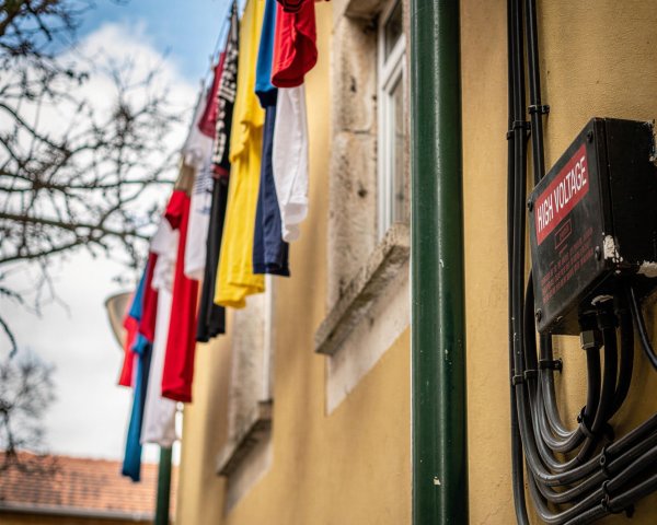 Close-up of Yellow Building with T-Shirts on Clothesline