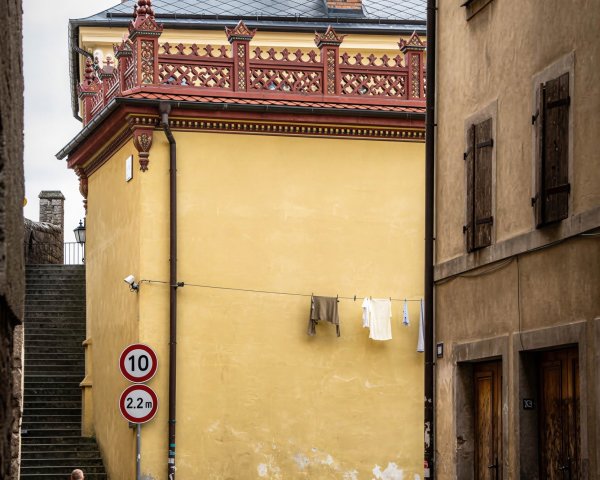Cobblestone Street with Ornate Buildings and Security Cameras