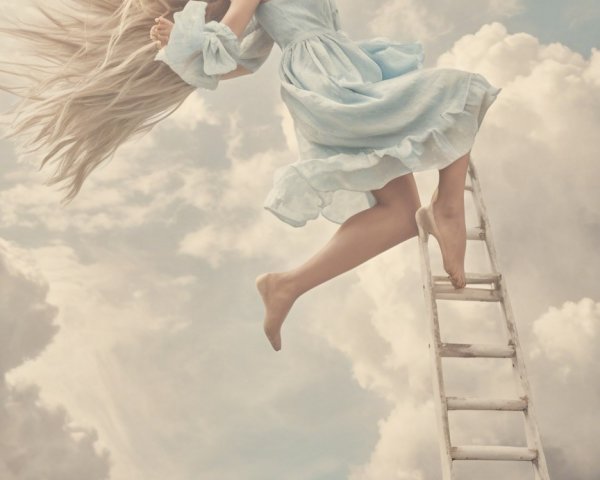 Young Woman in Light Blue Dress Descending Ladder