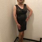 Confident Individual in Stylish Black Dress and Accessories