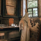 Solitary Figure in Dimly Lit Room with Wine Glass