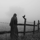 Mysterious Figure by Grave Gate Under Cloudy Sky
