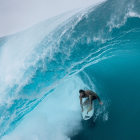 Surfer Riding a Massive Wave in Turquoise Waters
