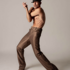 Dynamic Pose of Male Model in Orange Shirt and Pants