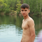 Young man by tranquil pool in summer setting