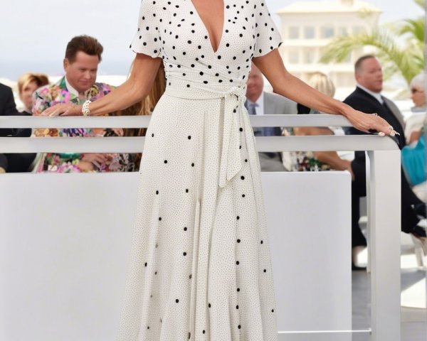 Stylish Woman in Polka Dot Dress Outdoors with Crowd