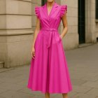 Elegant Woman in Pink Wrap Dress with Architectural Backdrop