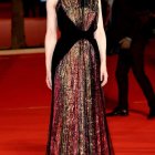 Confident Figure in Floral Gown on Red Carpet
