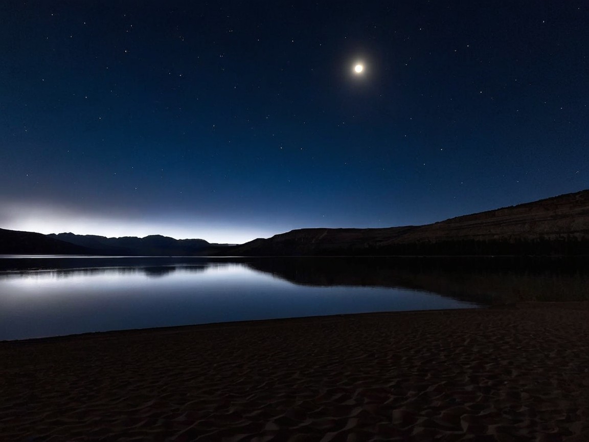 Serene Night Landscape with Lake and Crescent Moon