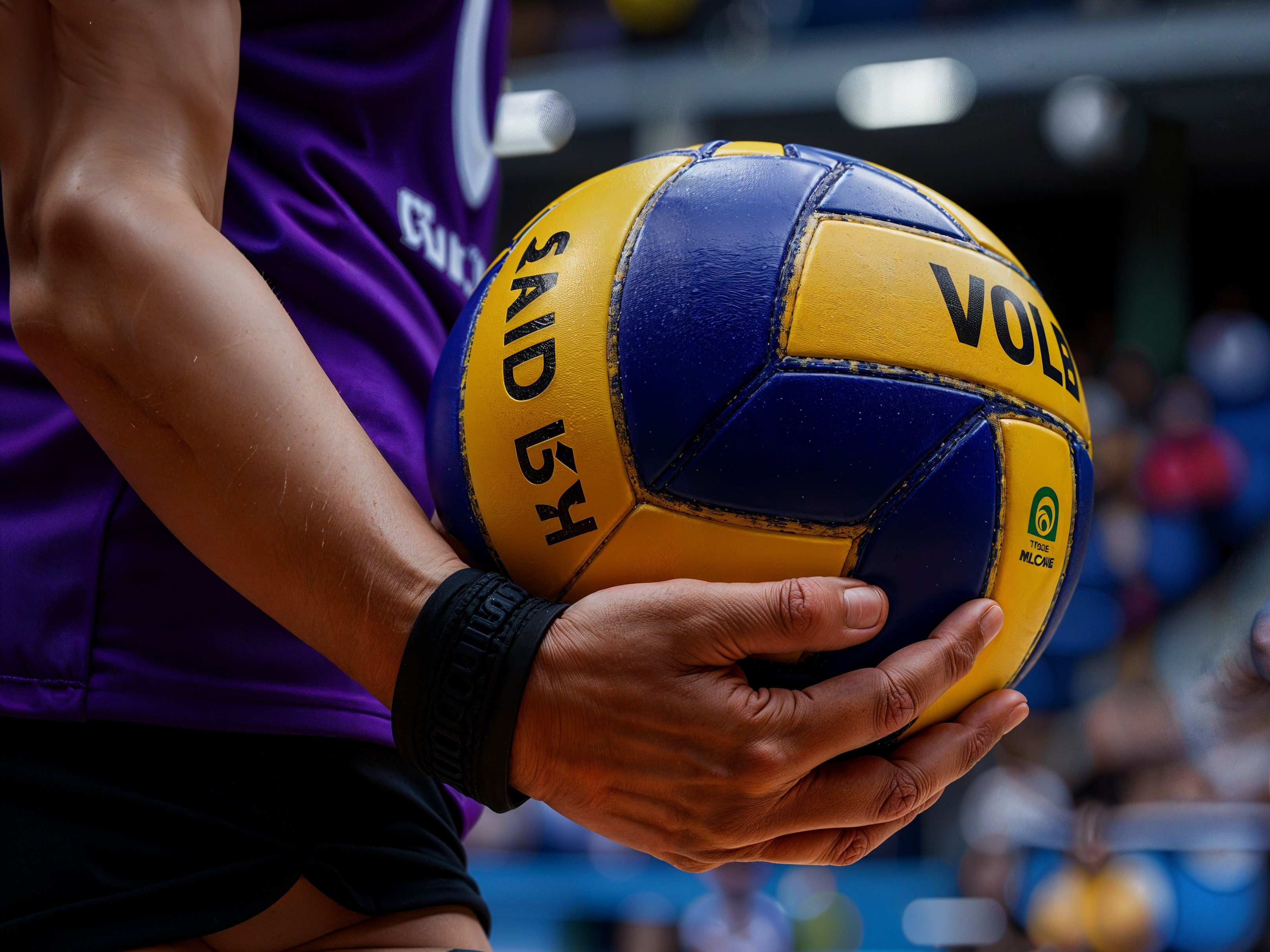 Athlete's Arm with Blue and Yellow Volleyball Close-Up