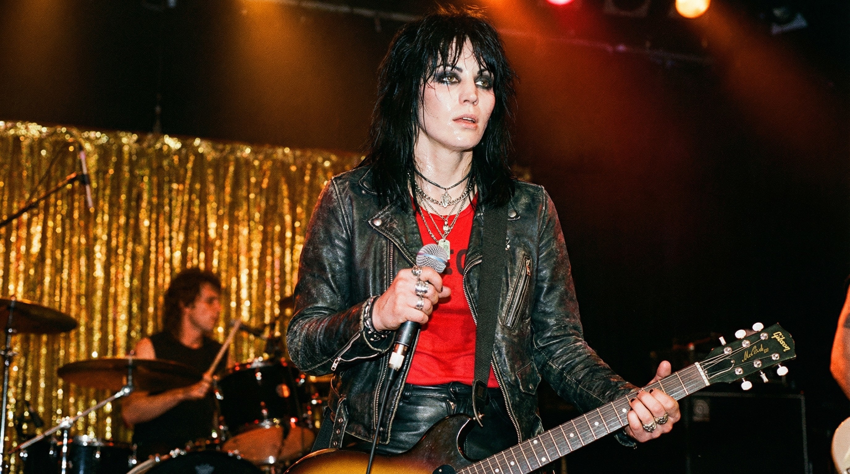 Androgynous Musician Performing on Stage with Band Member