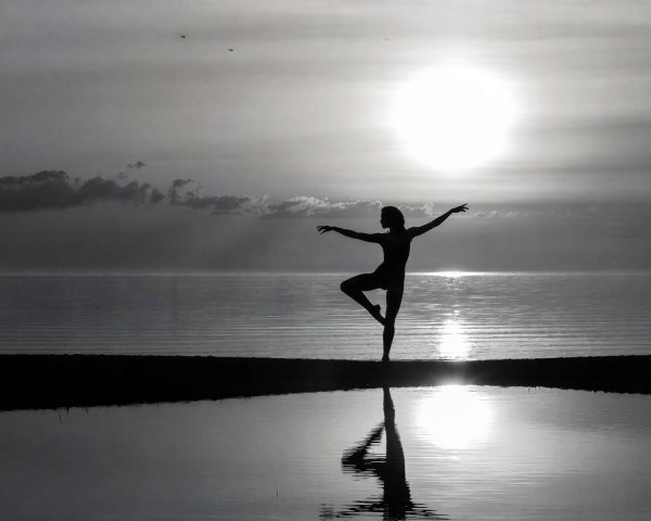 Silhouette of a Dancer in Ballet Pose at Sunset