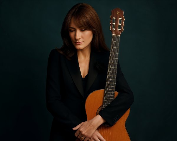 Woman with Guitar Against Dark Turquoise Background