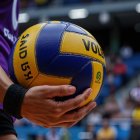 Athlete's Arm with Blue and Yellow Volleyball Close-Up