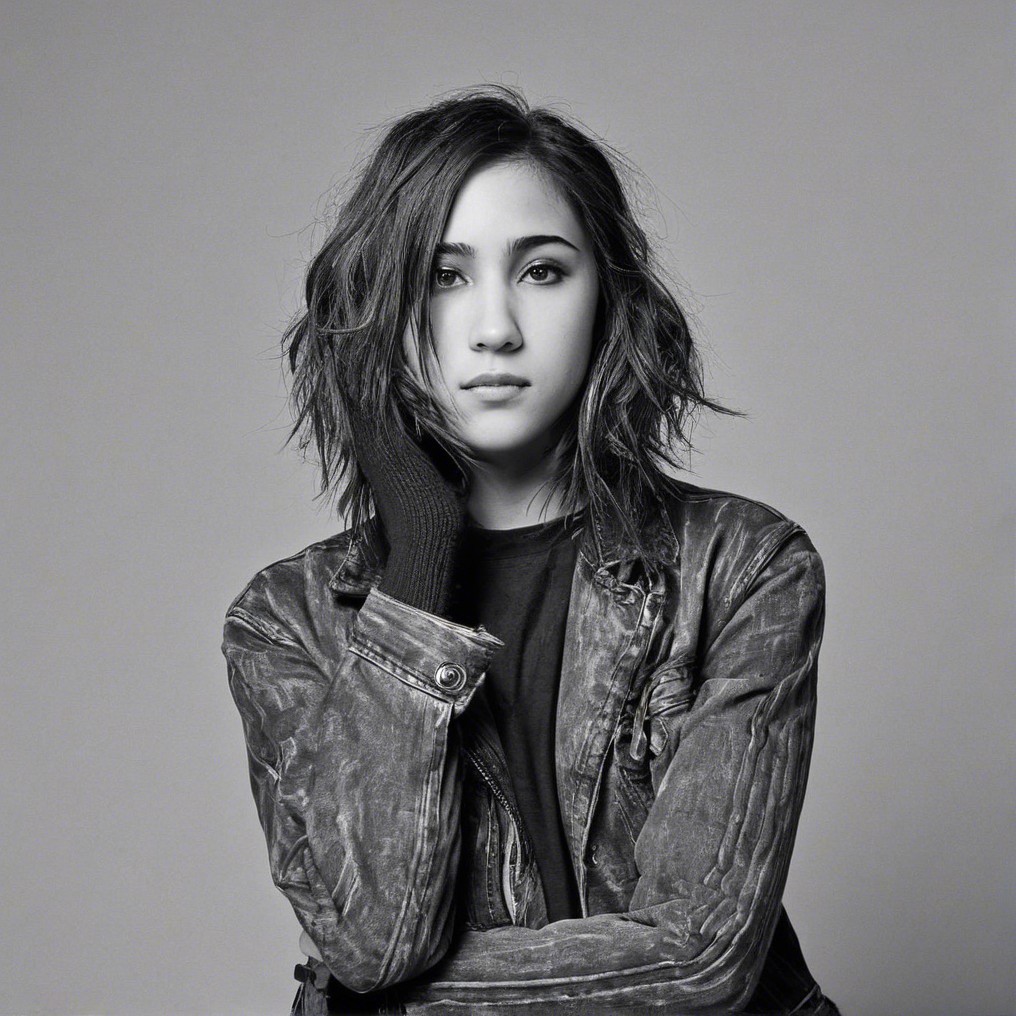 Young woman in leather jacket with contemplative expression