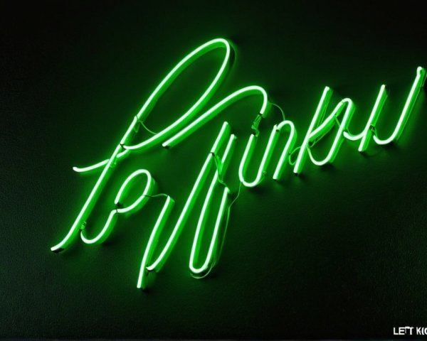 Vibrant Green Neon Sign of "PINKS" on Dark Background