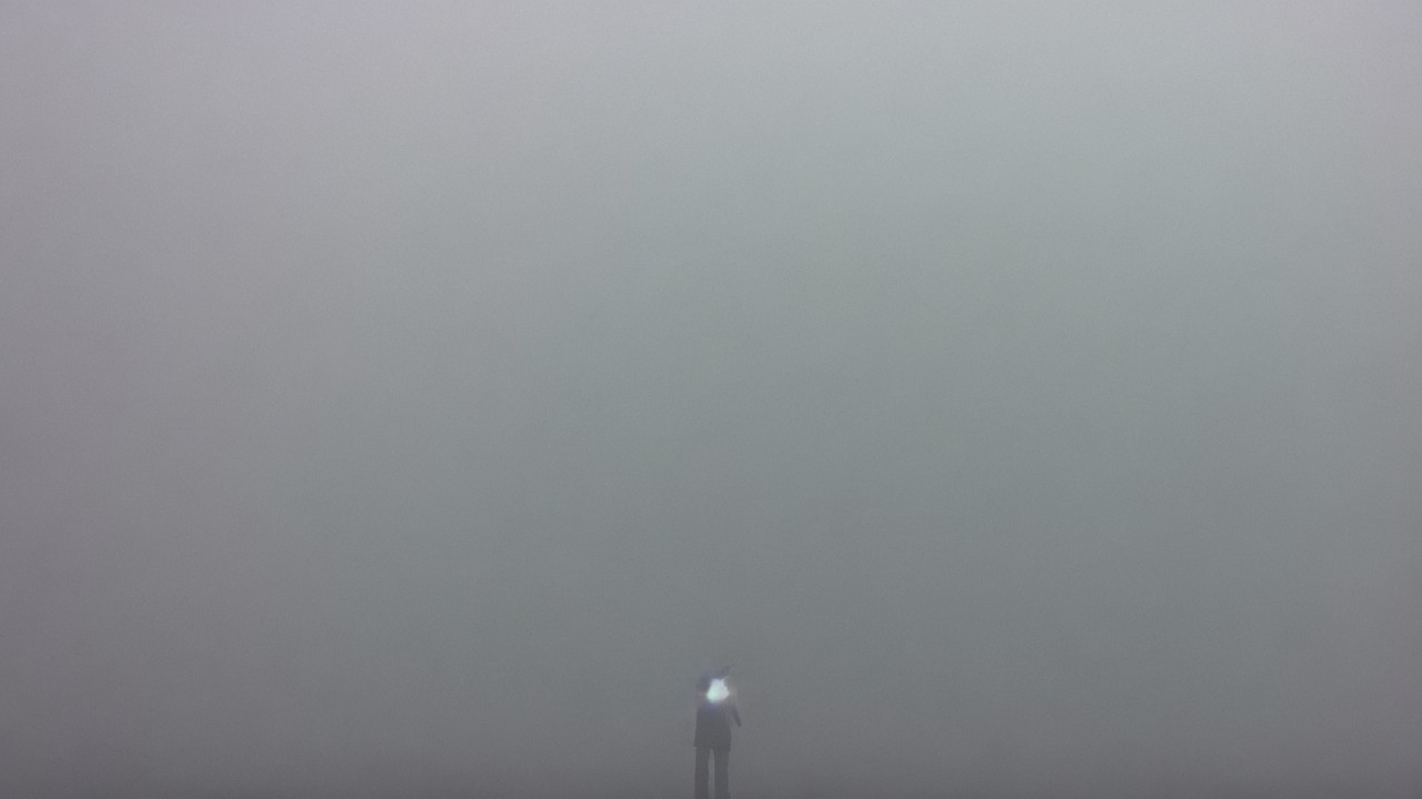 Solitary Figure in a Foggy Landscape Evoking Mystery