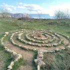 Vibrant Landscape with White Structures and Green Hills