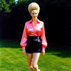 Fashionable woman in pink blouse and black shorts