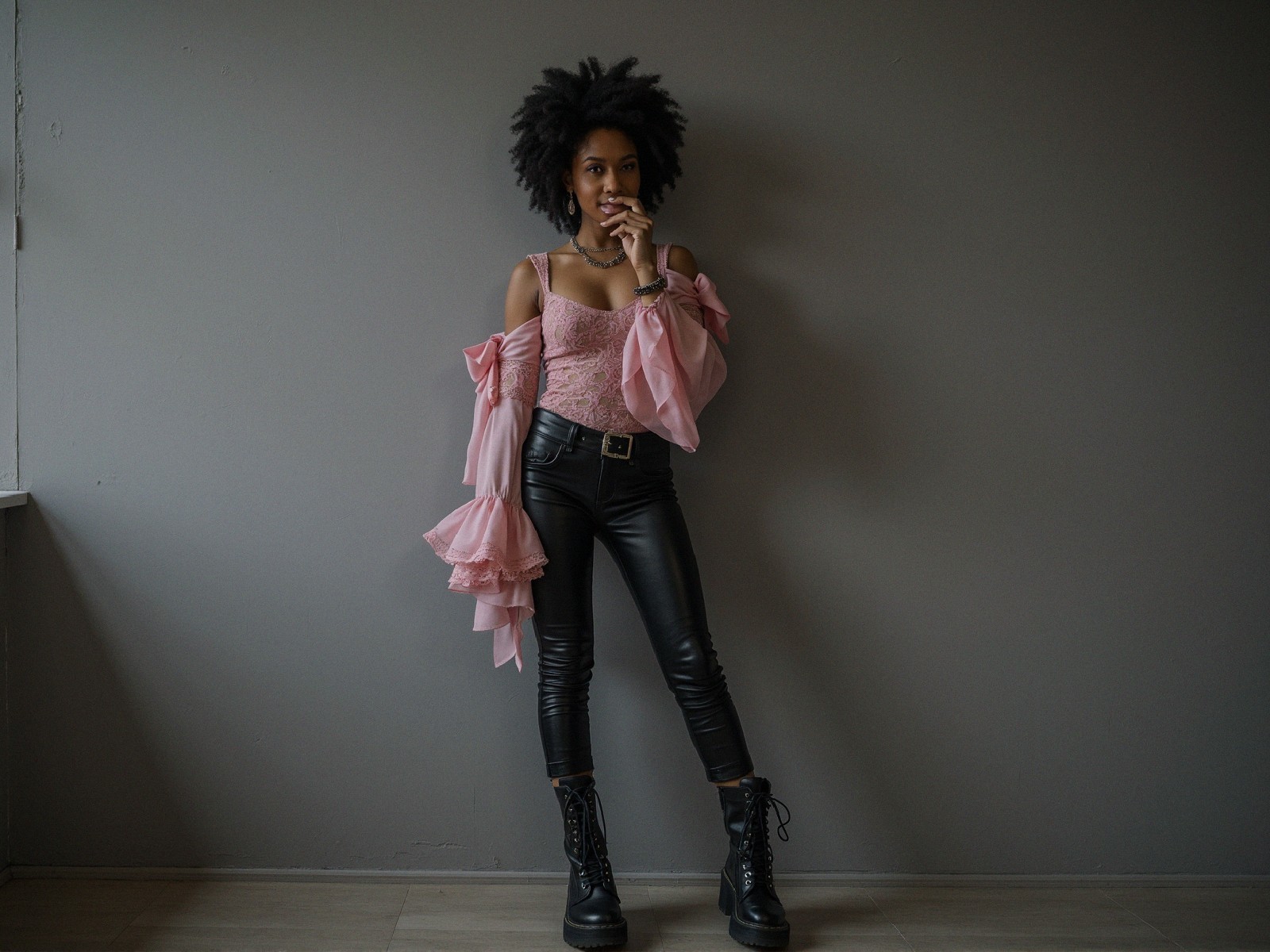 Confident Young Woman in Edgy Fashion Against Wall