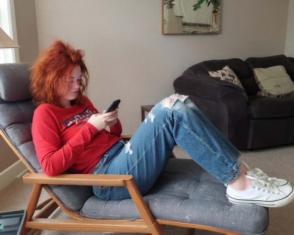 Young woman with red hair in modern lounge chair