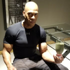 Muscular Man Lifting Dumbbell in Gym Setting